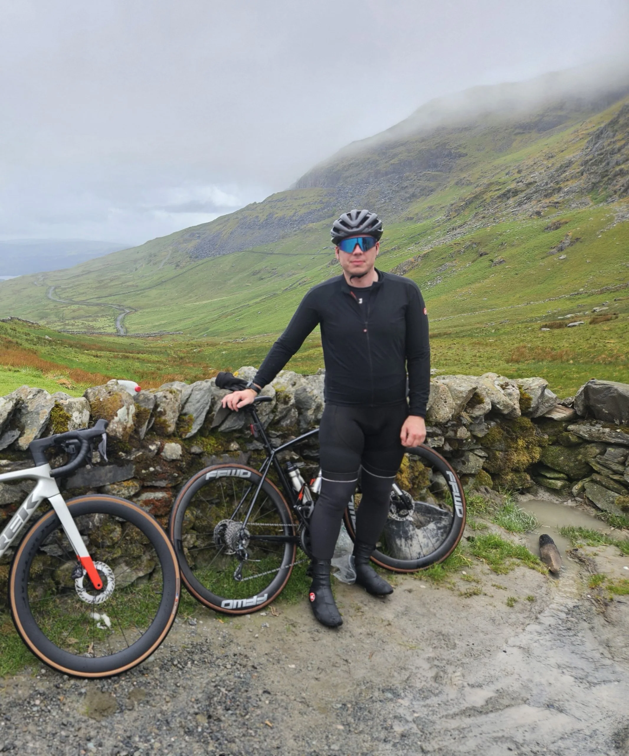 Me standing up on a high peak in the Lake District, with my bike on a very misty day.