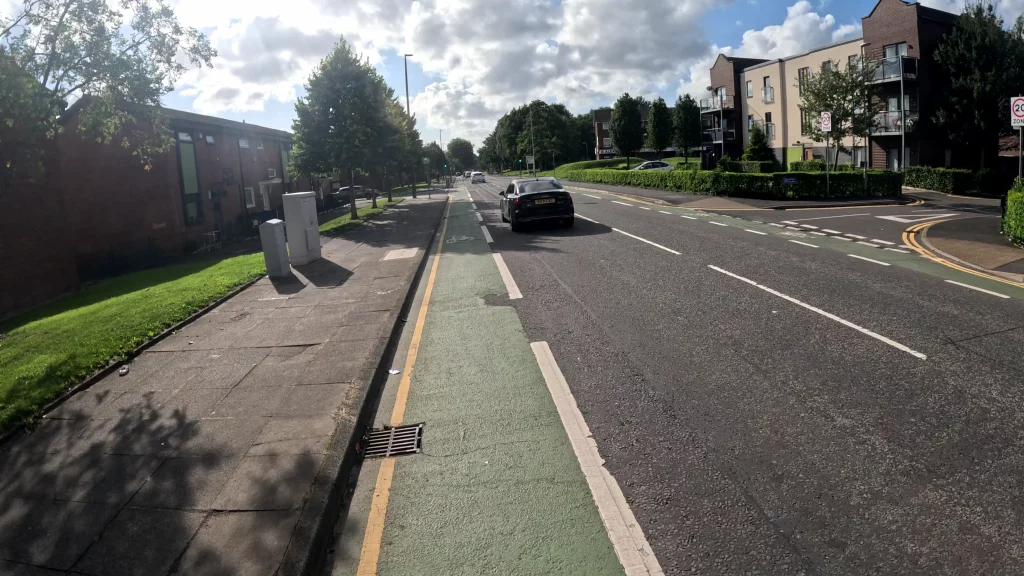 Quiet street with slow cycling on a cycle lane on a sunny afternoon