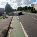 Quiet street with slow cycling on a cycle lane on a sunny afternoon
