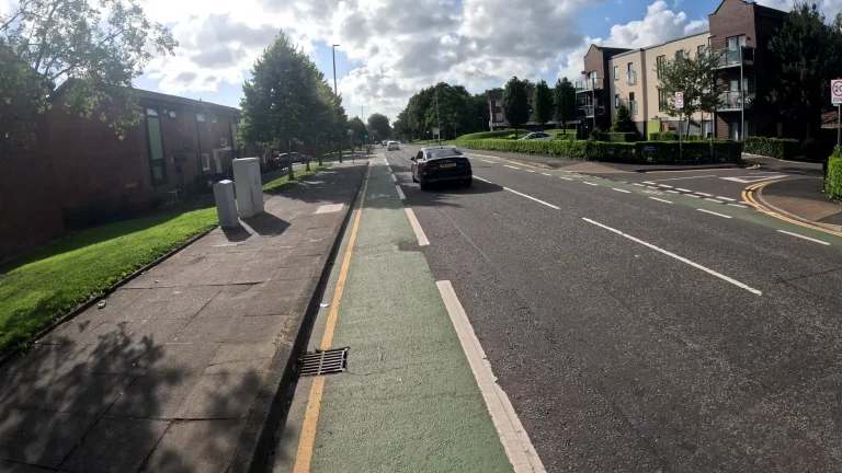 Quiet street with slow cycling on a cycle lane on a sunny afternoon