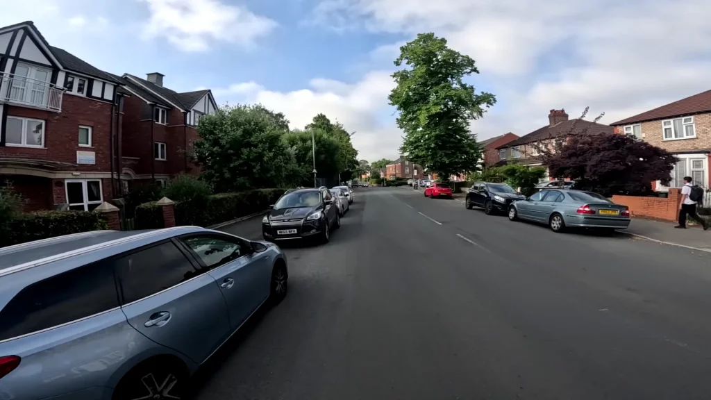 Healmet cam viewpoint of a Quiet street with parked cars