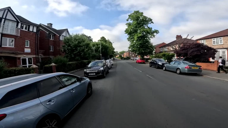 Healmet cam viewpoint of a Quiet street with parked cars