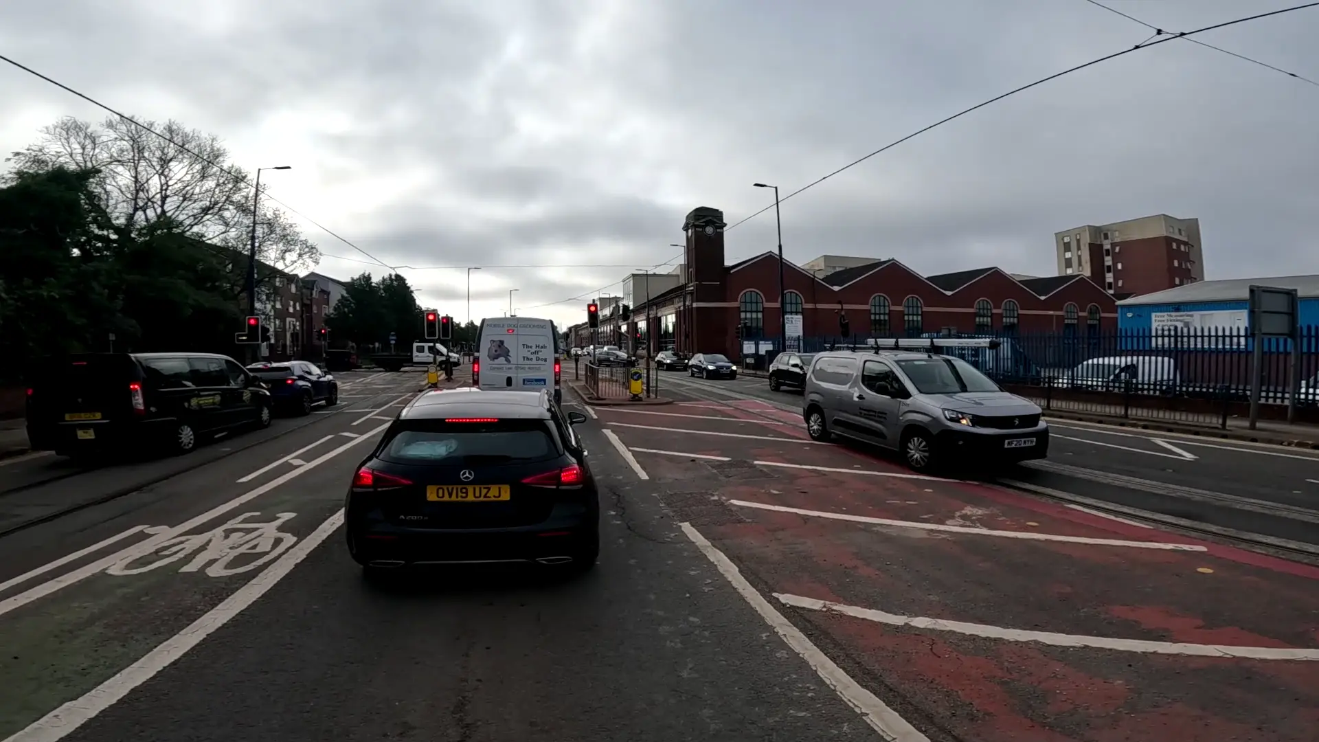 A cyclist taking the centre of the lane in traffic for safety