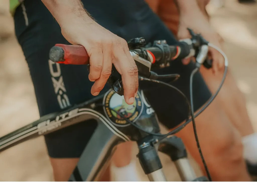 A mountain biker pressing both brake levers